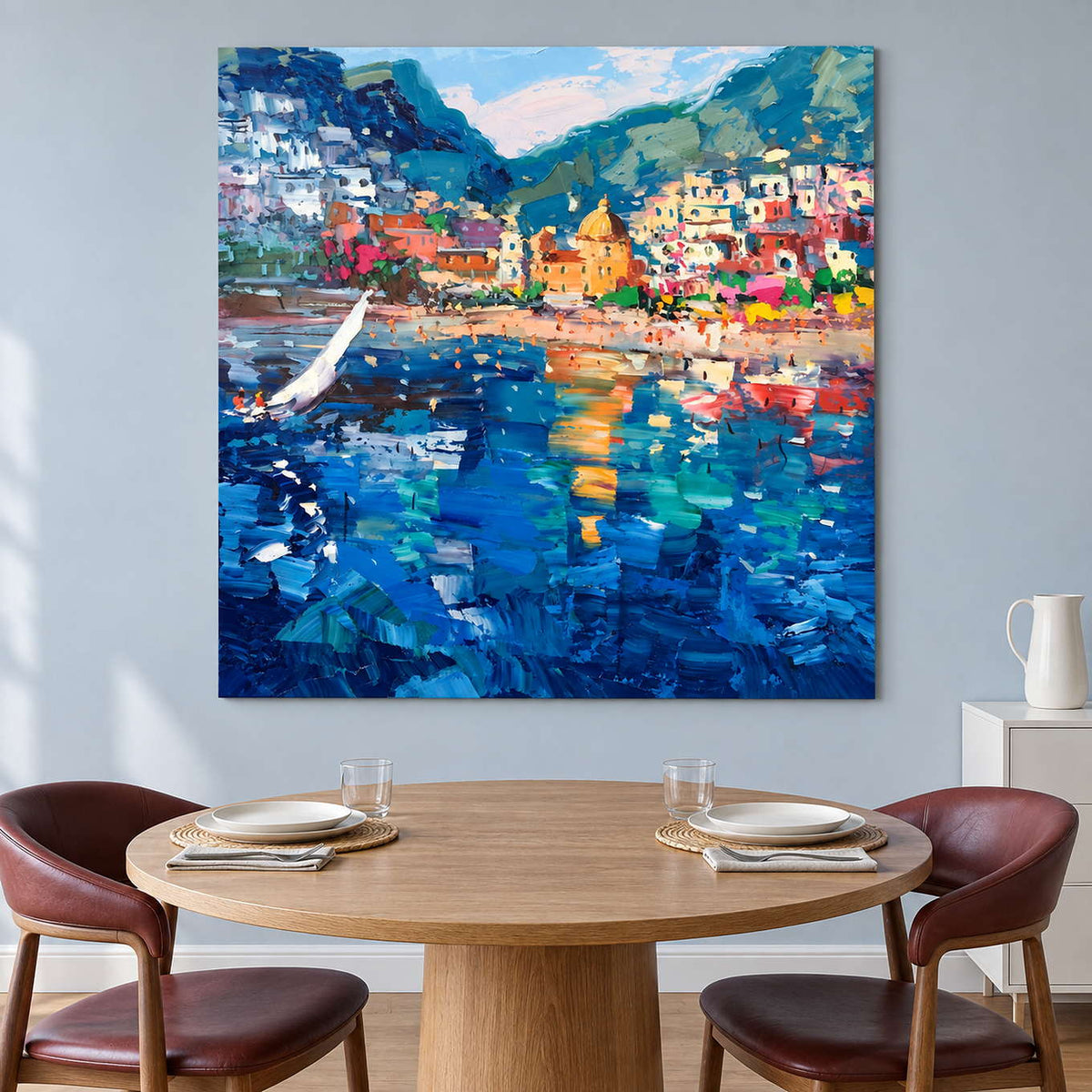 Blue harbor artwork behind a round table with burgundy chairs.