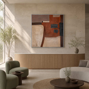 Silver framed earth toned abstract painting above a wood paneled wellness reception counter.