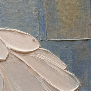 Close detail of sculpted ivory petals and layered blue gold paint