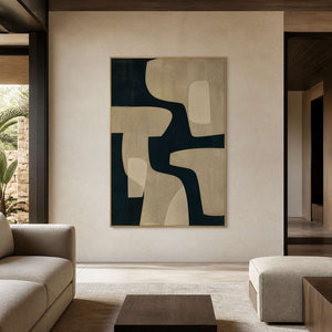 Black and beige abstract wall art displayed in a warm stone walnut living room.