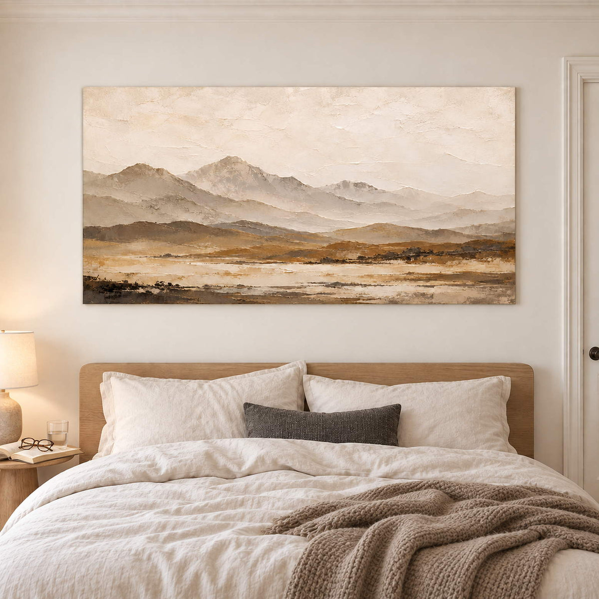 Soft taupe mountains above a muted ochre plain without an outer frame, displayed above a bed.