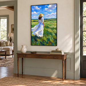 The Fields Await in a black frame above a turned-leg wood console against a softly paneled hallway wall.