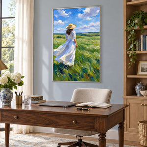 The Fields Await in a silver frame above a dark wood desk and cream chair against a pale blue office wall.