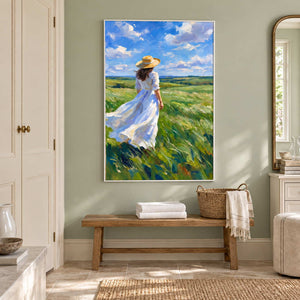 The Fields Await in a white frame above a wood bench holding folded towels and a basket beside a bathroom vanity.