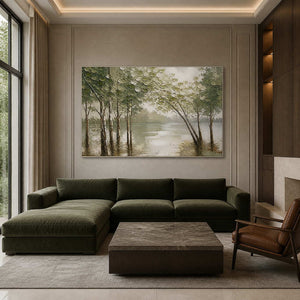 Olive woodland artwork displayed above a deep green modern sofa.