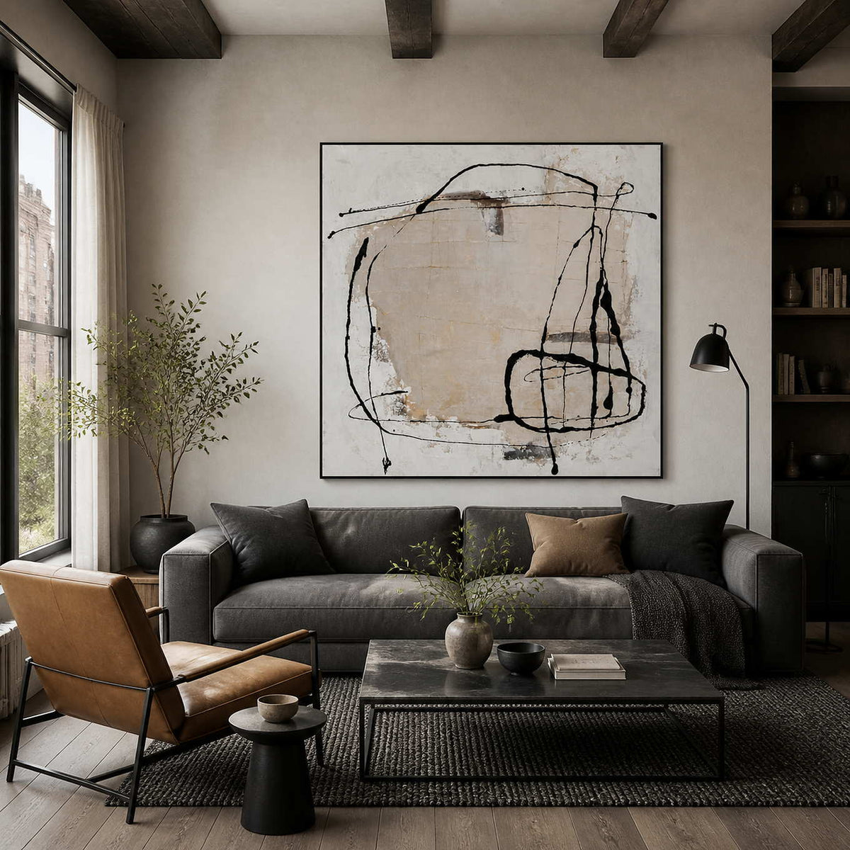 Black-framed abstract wall art above a charcoal sofa in a warm living room.
