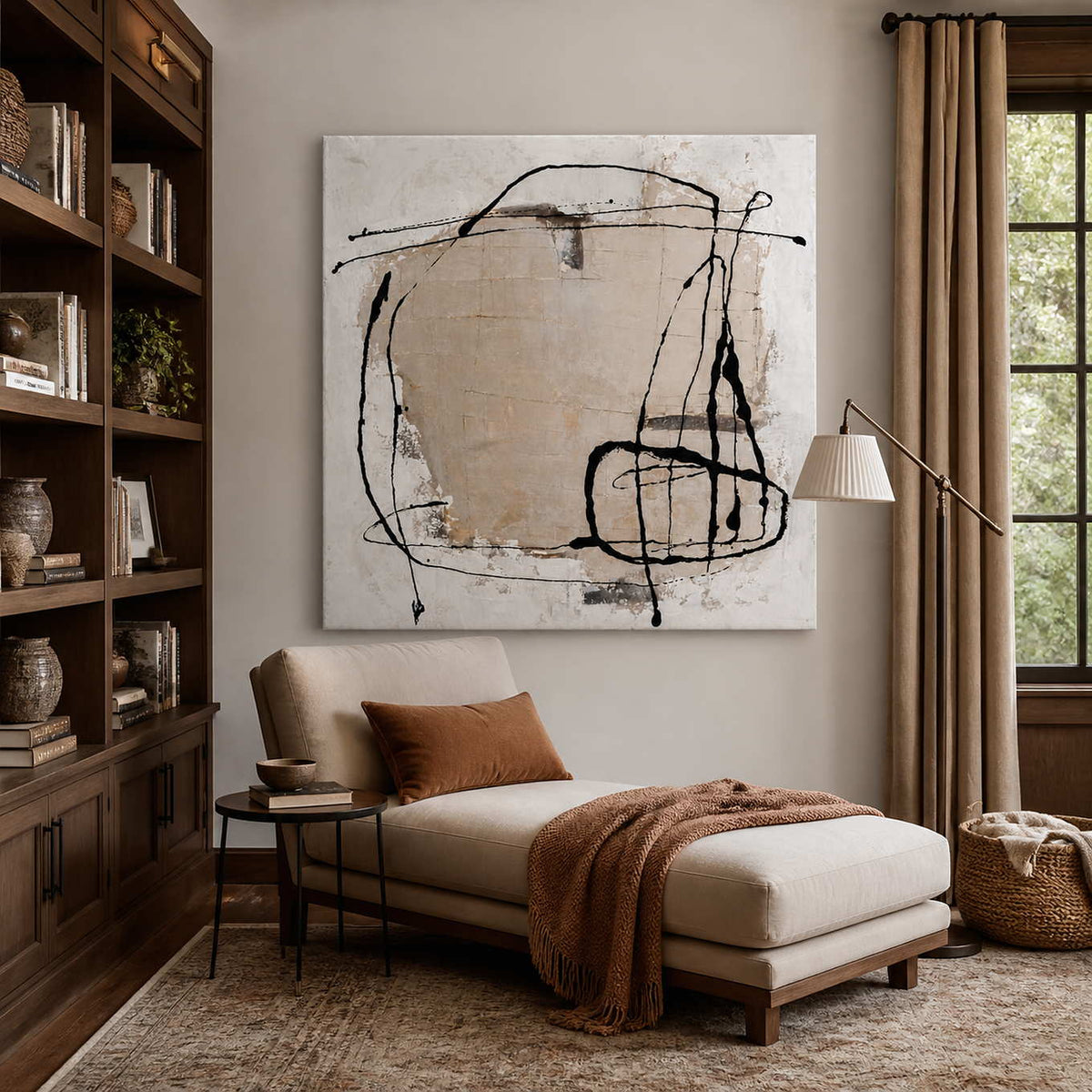 Frameless abstract wall art above a cream chaise beside bookcases in a reading room.