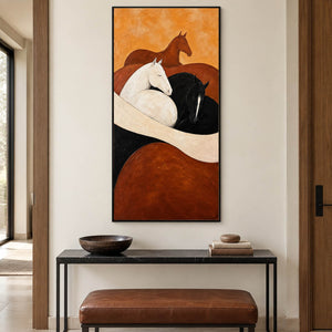 Brown, white, and black horse painting with cream and rust curves in a black frame in an entryway.