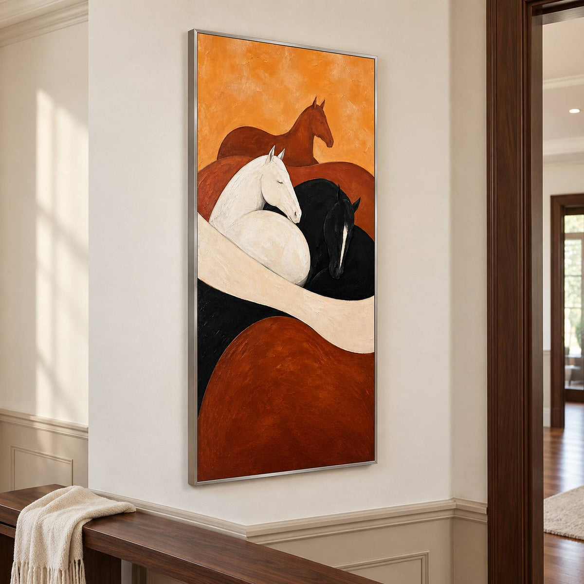 Brown, white, and black horse painting with cream and rust curves in a silver frame in a hallway.