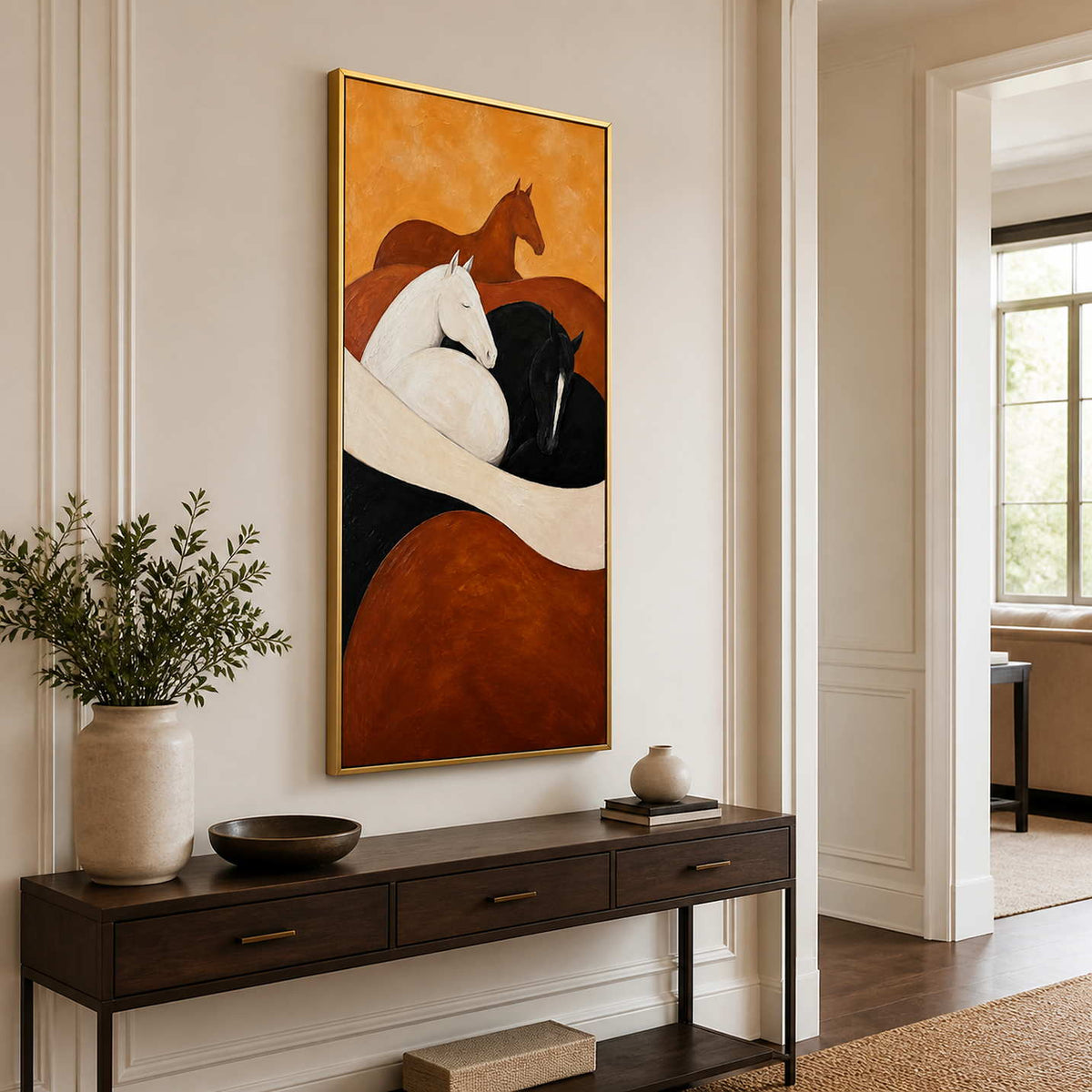 Gold framed horse painting above a slim wooden console in a bright hallway.