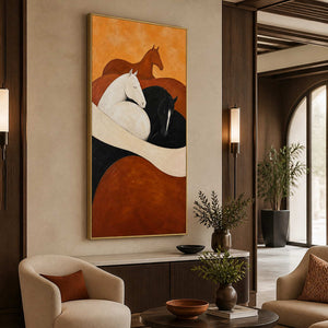 Gold framed equestrian painting above a fluted console beside warm hotel lounge seating.