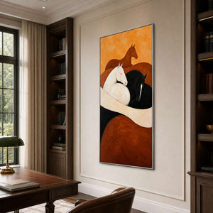Silver framed horse artwork between dark bookcases behind a leather topped study desk.
