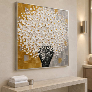 Angled view of the floral painting above a pale console with folded white towels.
