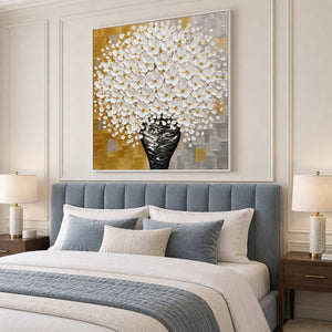 Square white bouquet painting above a blue-gray headboard and coordinated bedding.