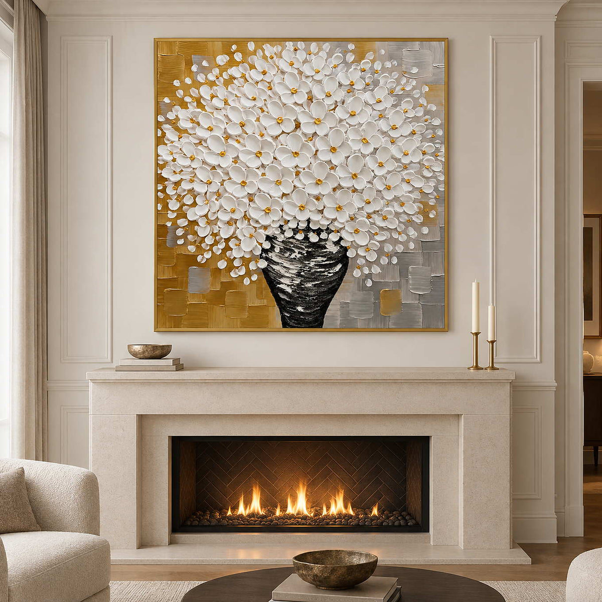Gold-toned framed bouquet artwork above a cream fireplace with candles on the mantel.