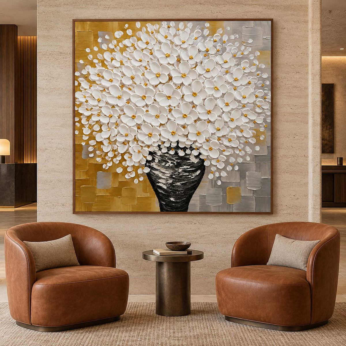 Large white floral painting above two brown leather chairs and a small round side table.