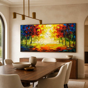 Black-framed woodland landscape above a walnut sideboard beside an upholstered dining set.