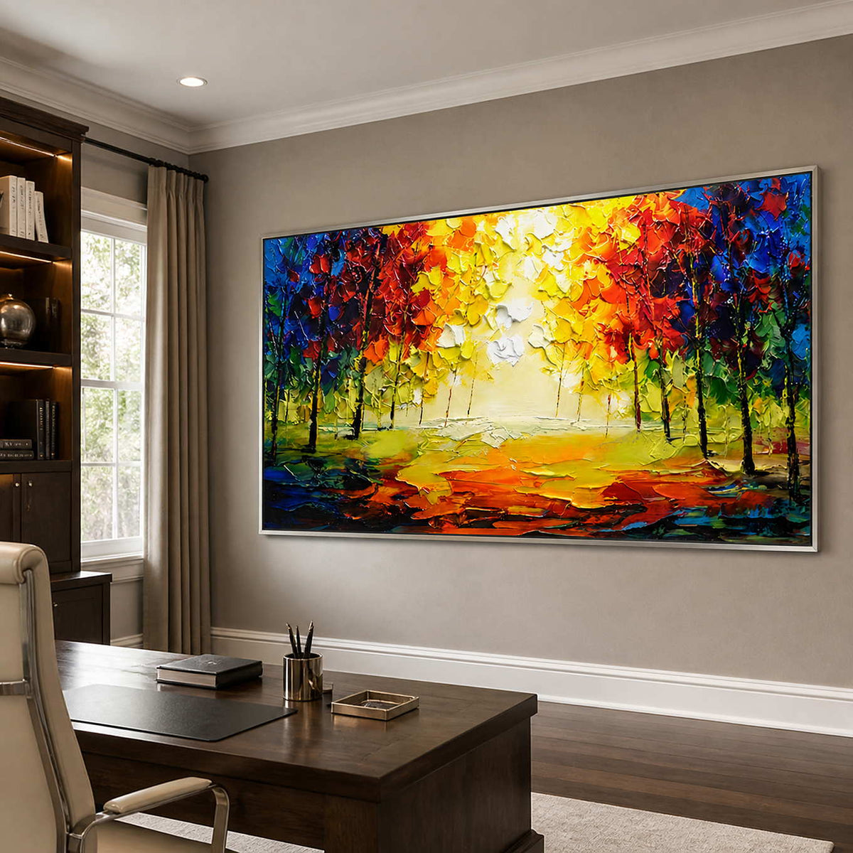 Silver-framed woodland landscape with vivid foliage above a dark wooden office desk.