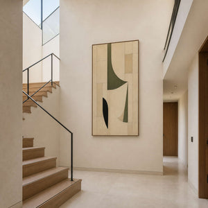 Neutral geometric wall art displayed beside a light stone residential staircase.
