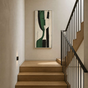 Tall green geometric canvas displayed beside a contemporary staircase.