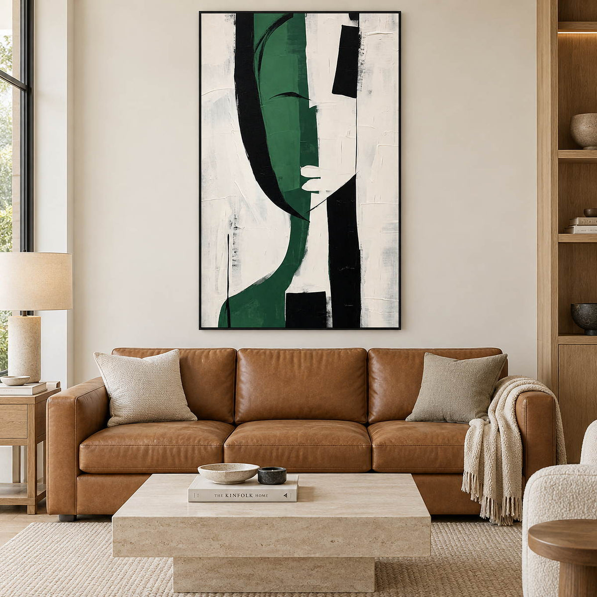 Hand-painted vertical canvas with deep green, black, and white forms, displayed in a living room in a black frame.