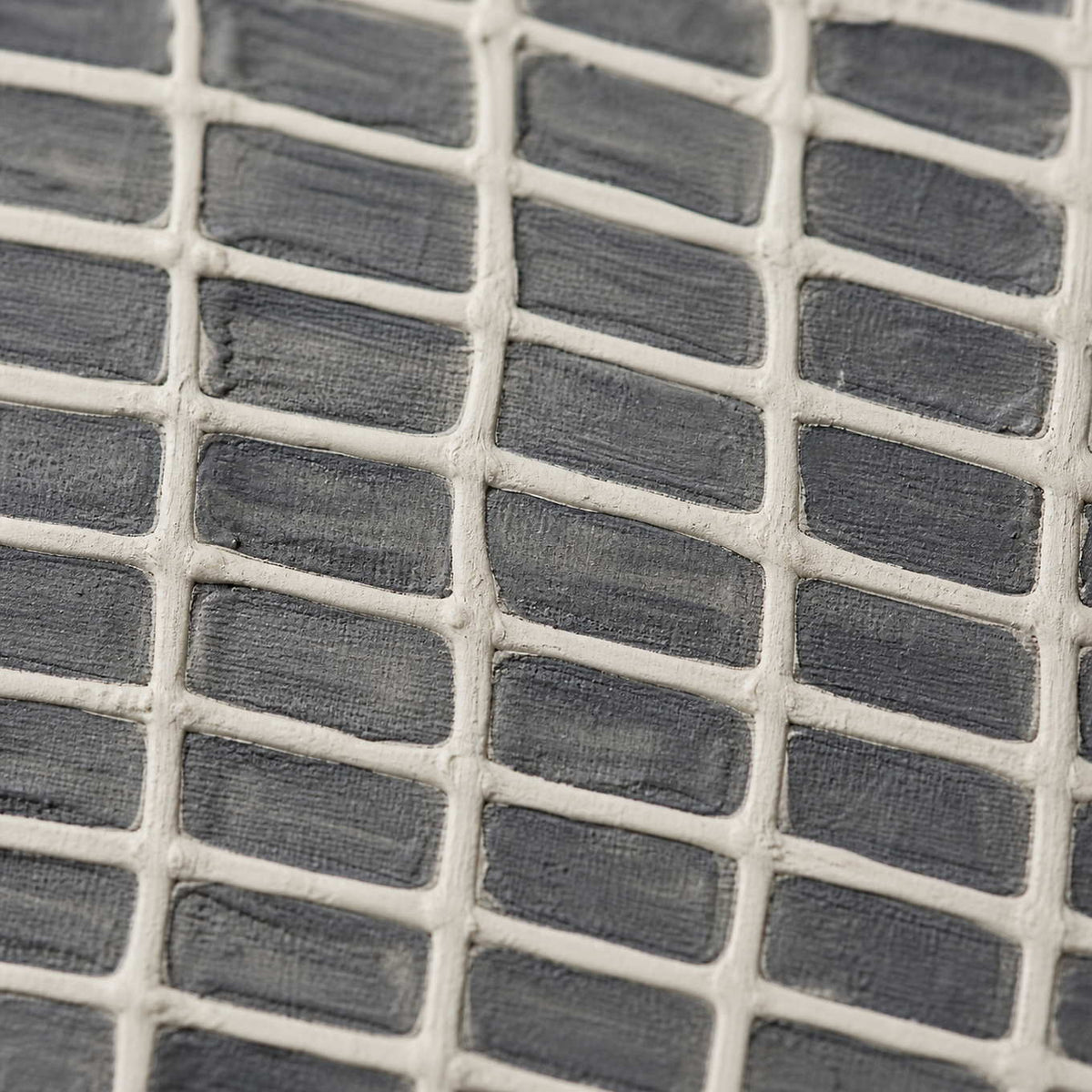 Close-up of raised ivory lattice over layered gray paint.