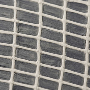 Close-up of raised ivory lattice over layered gray paint.