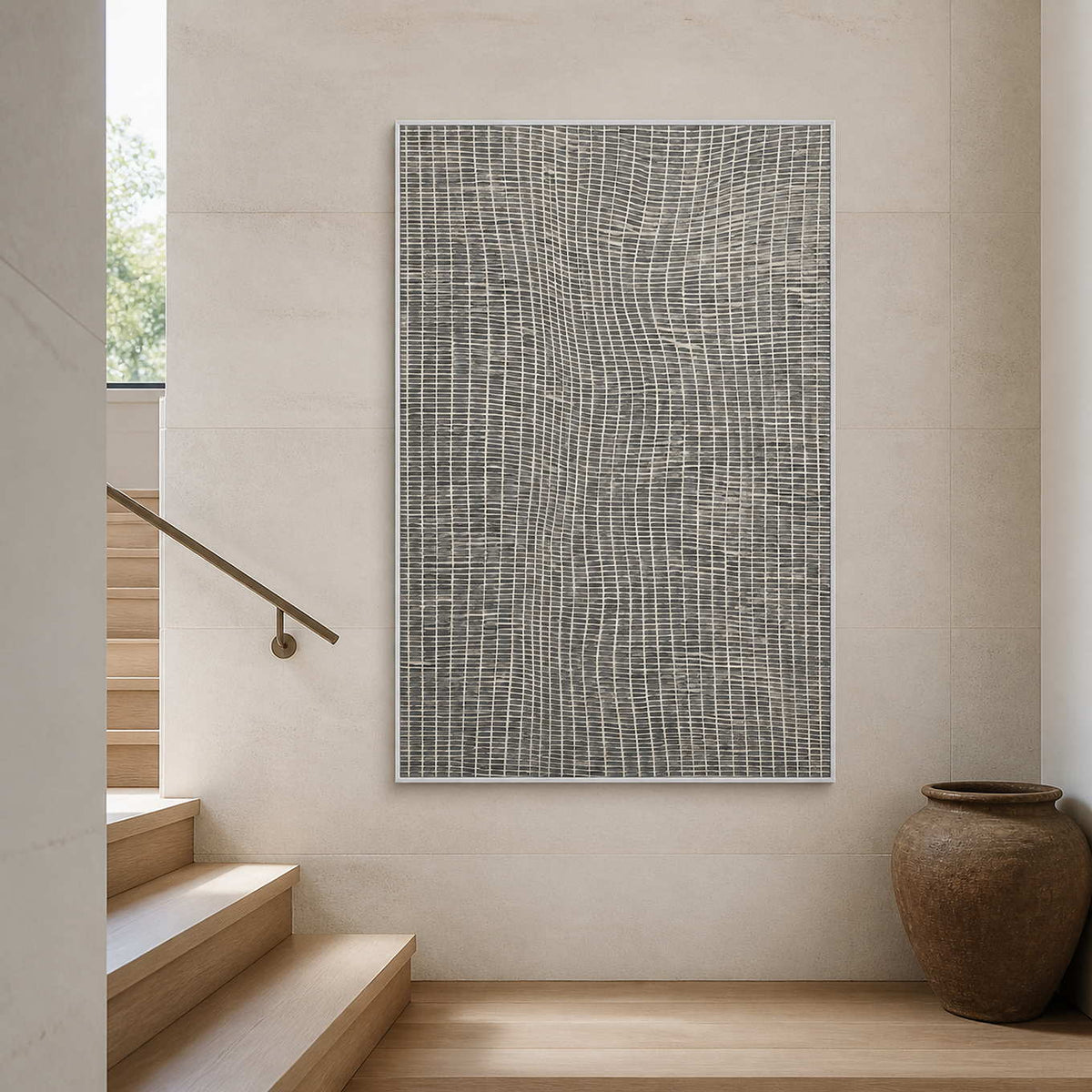 Vertical minimalist artwork displayed beside a warm white stairway.