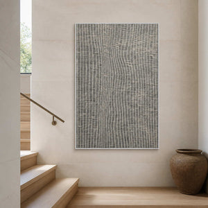 Vertical minimalist artwork displayed beside a warm white stairway.