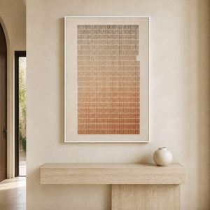 Minimalist textured artwork displayed above a pale stone entryway console.