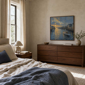 Square coastal sailboat wall art displayed above a dresser in a serene bedroom.