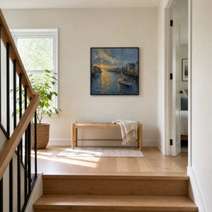 Square sailboat wall art displayed on a bright residential stair landing.