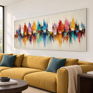 Panoramic harbor painting with colorful sail-like shapes and reflections in a white frame in a lounge.