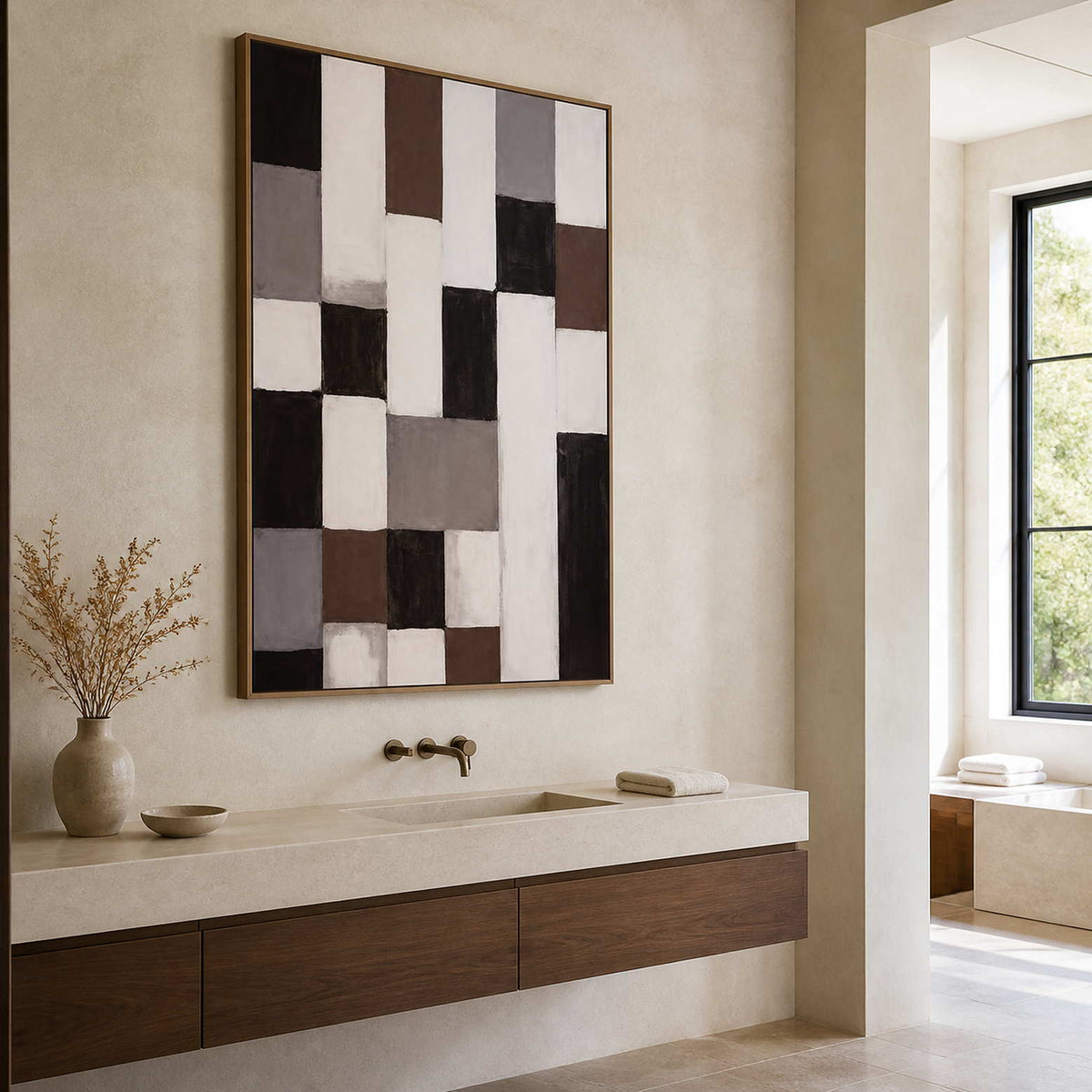 Wood framed geometric abstract artwork above a pale stone vanity with a wooden cabinet.