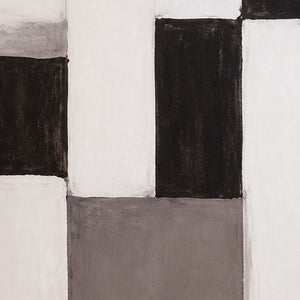 Close view of softly painted edges between cream, charcoal, and gray rectangular color blocks.