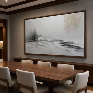 Quiet monochrome landscape wall art in a dining room with a wood frame.