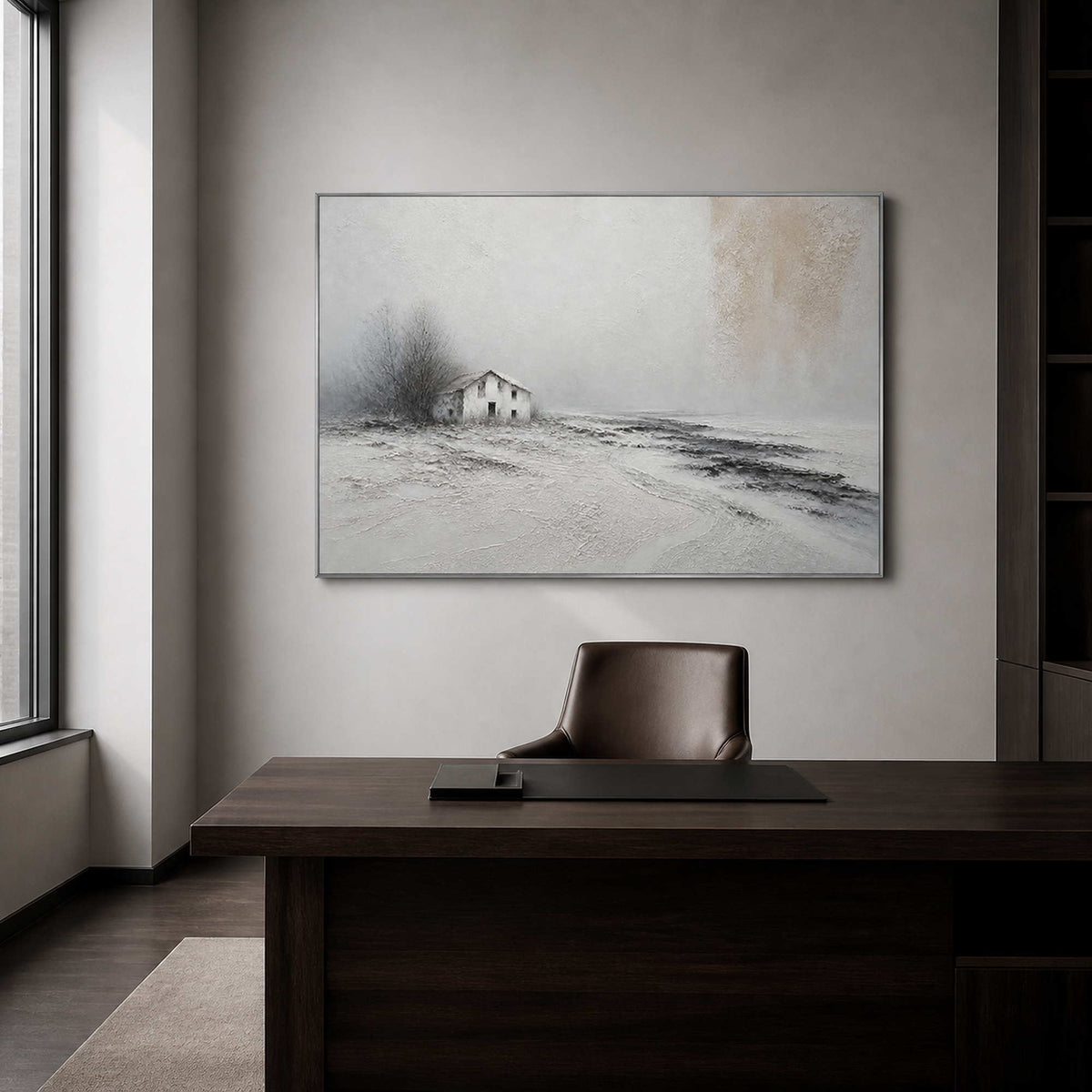 Minimalist winter landscape wall art in a sophisticated office with a silver frame.