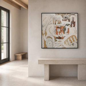 Black framed square abstract artwork above a stone console in an airy residential entryway.