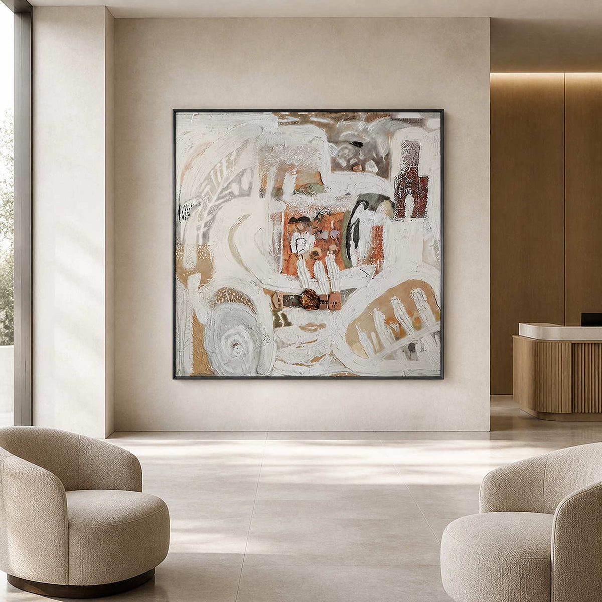 Black framed abstract artwork between cream lounge chairs in a boutique hotel reception.