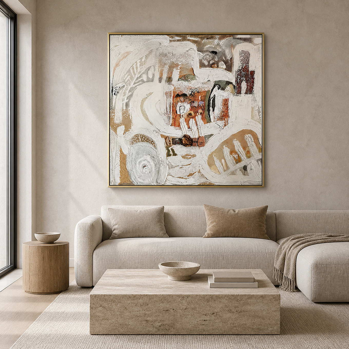 Gold framed textured abstract artwork above a cream sofa beside a sunlit window.