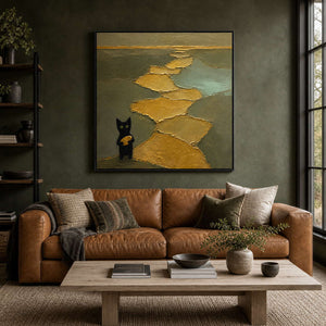 Textured black cat wall art styled above a warm modern living room sofa.