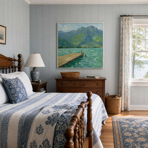 Blue-green mountain artwork above a serene lake-house bedroom dresser.