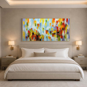 Bright textured abstract wall art adding color above a serene neutral bed.