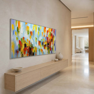 Bright abstract wall art creating an uplifting focal point in a long entryway.