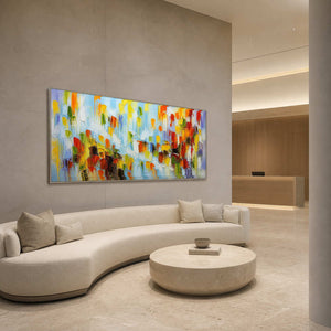 Panoramic multicolor wall art displayed in a spacious modern hotel lobby.