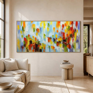Panoramic colorful abstract wall art displayed in a sunlit modern lounge.