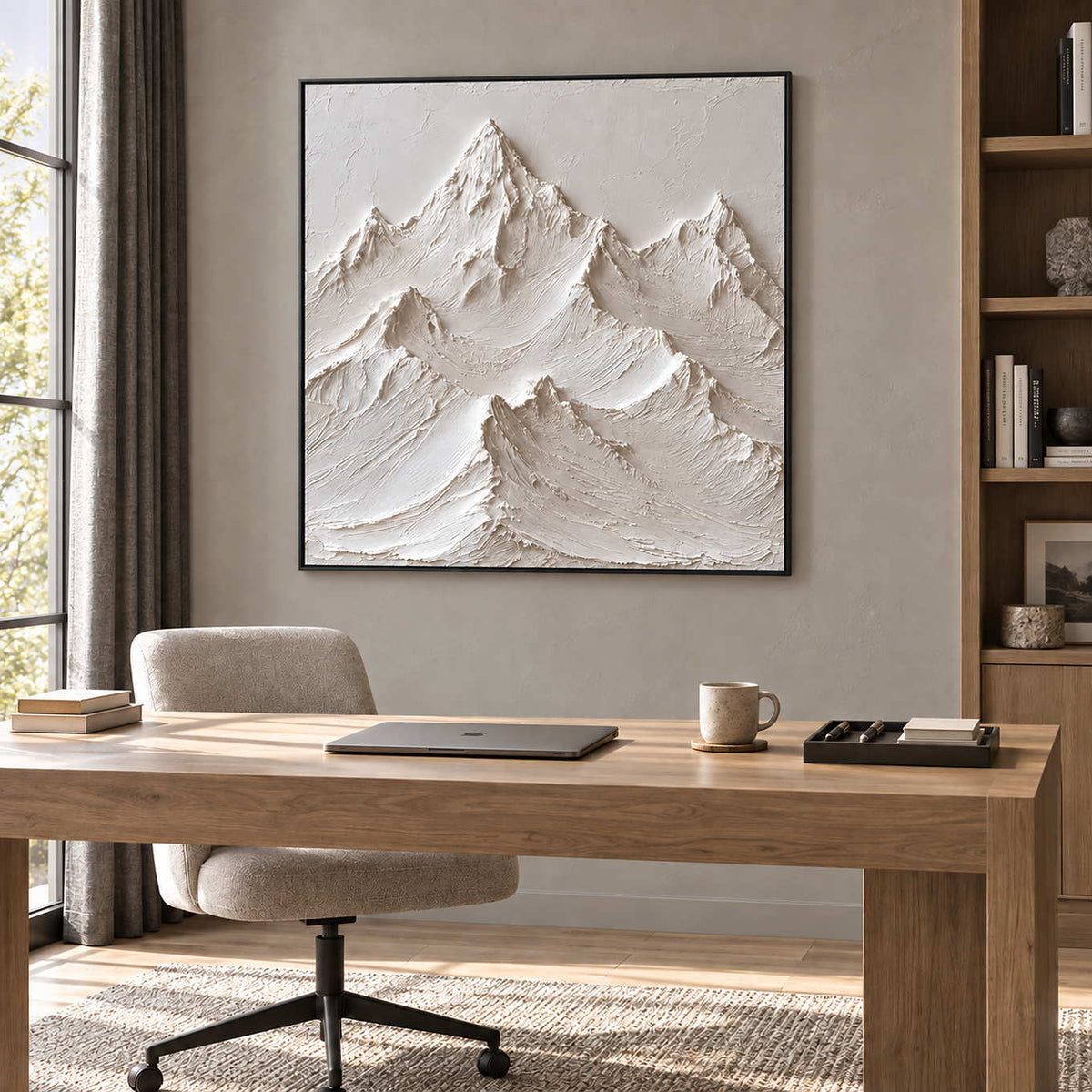 The Mountains Stand Watch in a black frame above a light wood desk and cream chair in a quiet study.
