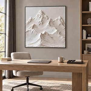 The Mountains Stand Watch in a black frame above a light wood desk and cream chair in a quiet study.