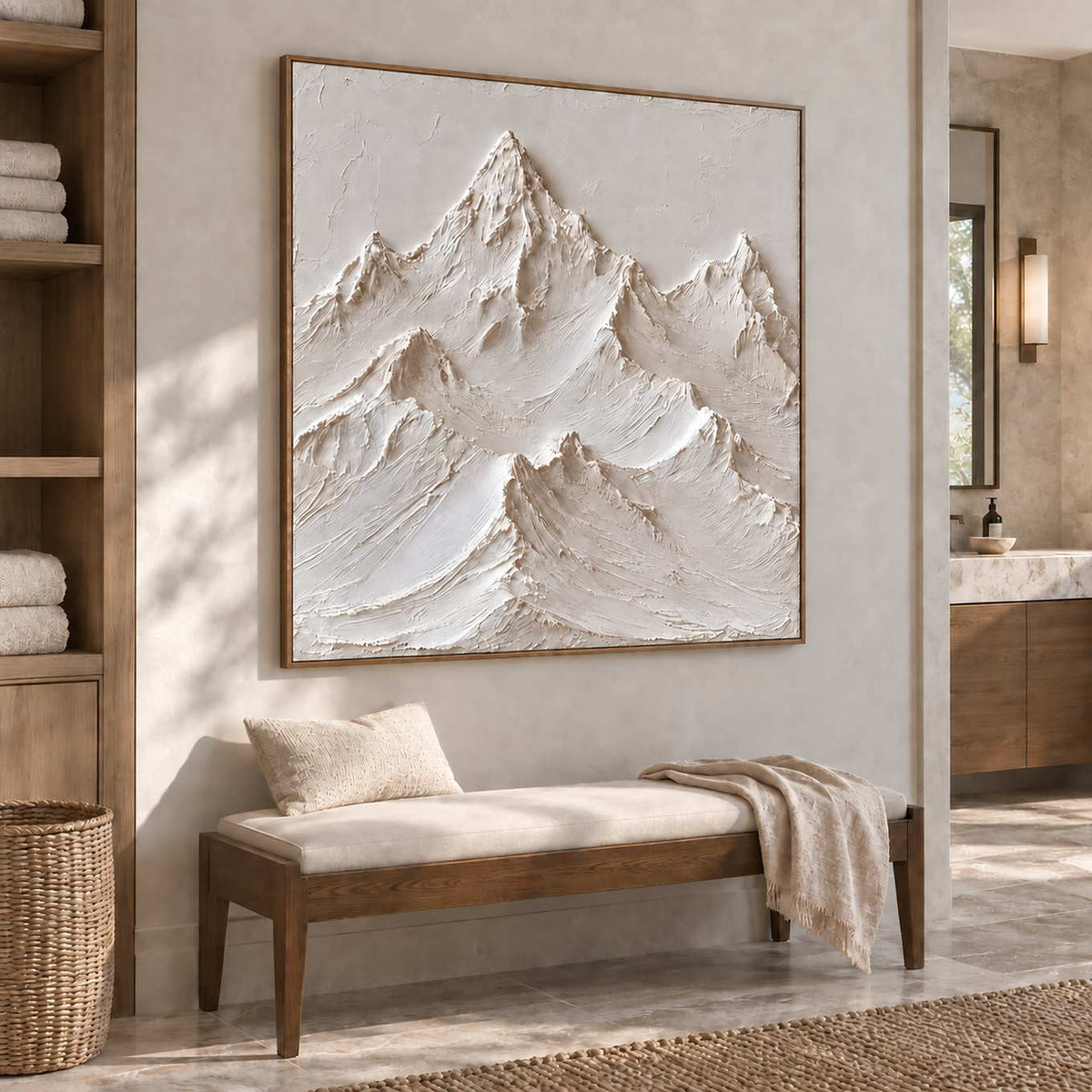 The Mountains Stand Watch in a wood frame above a pale cushioned bench beside towel shelving in a bathroom dry area.