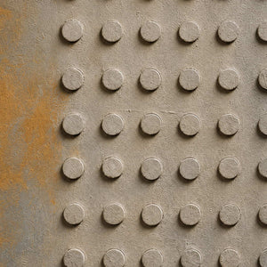 Close-up of raised hand-painted texture in neutral, white, and earth tones.